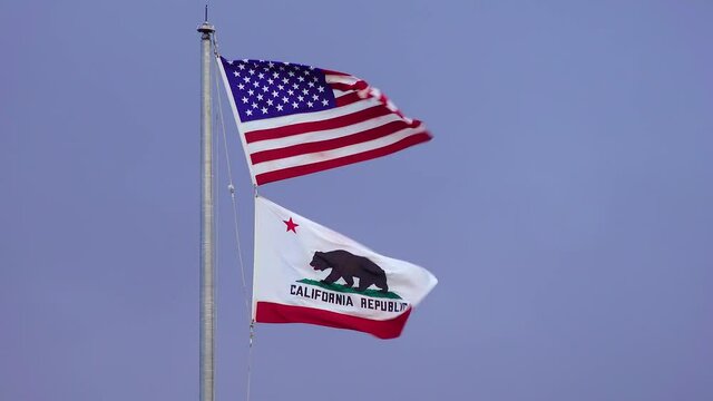 CALIFORNIA, USA - NOVEMBER  27, 2019: american flag and california flag fluttering in the wind, CA USA
