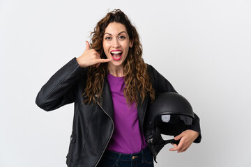 Young caucasian woman holding a motorcycle helmet making phone gesture. Call me back sign