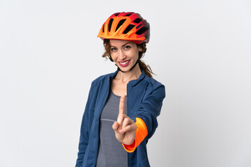 Young cyclist woman isolated on white background showing and lifting a finger