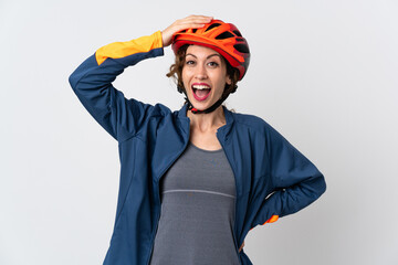 Young cyclist woman isolated on white background doing surprise gesture while looking to the side