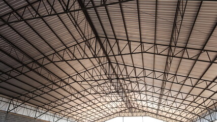 Steel structure warehouse roof. Roof details of industrial buildings or factories with steel structures and metal sheet roofs in the view below. Selective focus