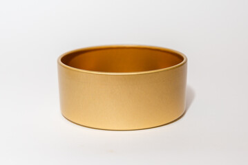 Yellow golden round empty metal box on white background.Soft focus,copy space.