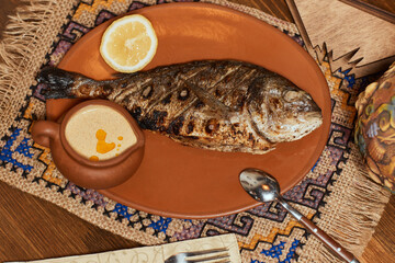 Grilled dorado with vegetables. Grilled fish. Top view.