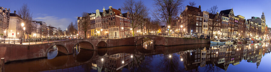 Panorama of the city waterfront of Amsterdam at sunset.