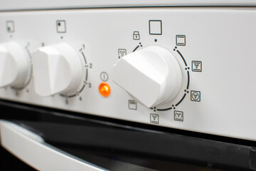 Close-up shot of a white cooker's front panel