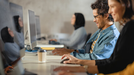 Smart Young Students Studying in University with Diverse Multiethnic Classmates. Scholars Collaborate in College Room with Computers. Applying Knowledge to Acquire Academic Skills in Class.