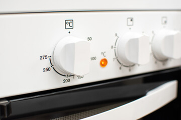 Close-up shot of a white cooker's front panel