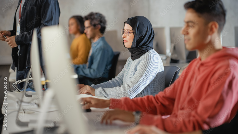 Aufkleber female muslim student in hijab, studying in university. she works on desktop computer in college wit