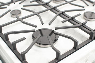 Close-up shoy of a rapid gas burner of a white gas hob