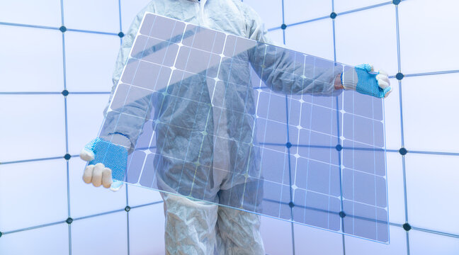 Translucent solar panels for use as window glass. Photovoltaic glass is  most cutting-edge new solar panel technology that   scope of solar. Transparent solar panel in the hands of a worker