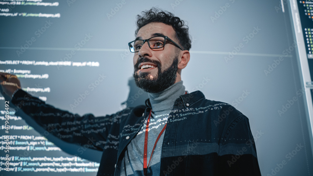 Fototapete Teacher Giving Computer Science Lecture to Diverse Multiethnic Group of Female and Male Students in Dark College Room. Projecting Slideshow with Programming Code. Explaining Information Technology.