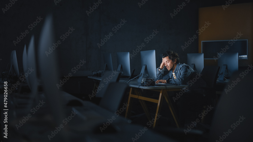 Poster Stressed Male Student Sitting Alone in College Informatics Room, Working Late Evenings on Computer Science Project. Tired Scholar Study IT on Computer in University, Writing Homework.