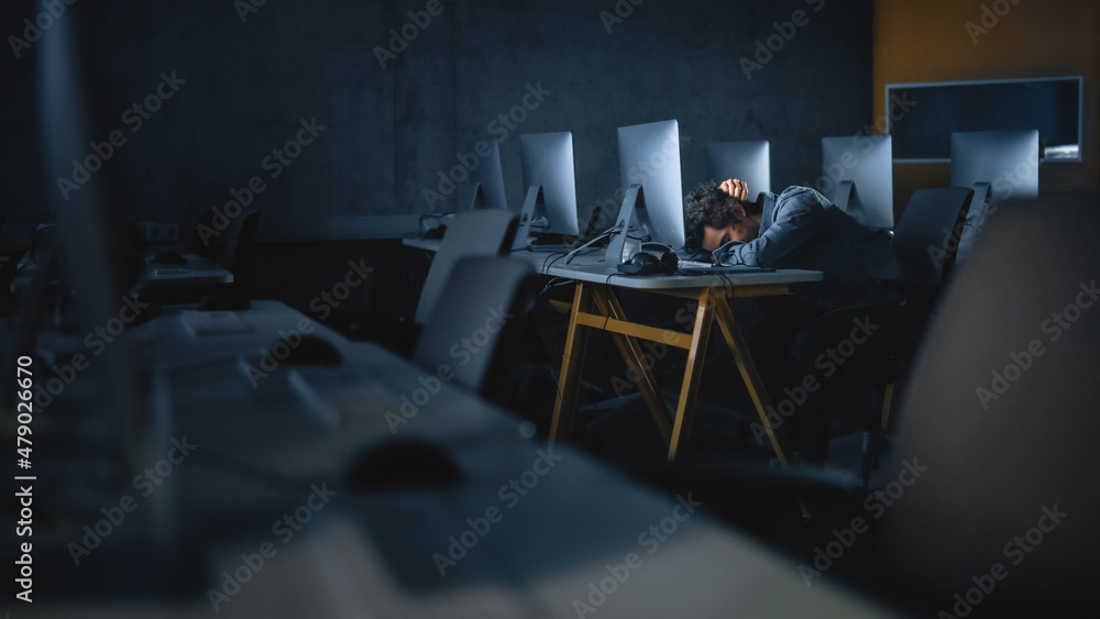 Aufkleber stressed male student sitting alone in college informatics room, working late evenings on computer s