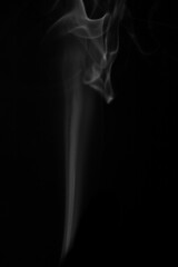 wax candle with burning wick and smoke, isolated on a black background