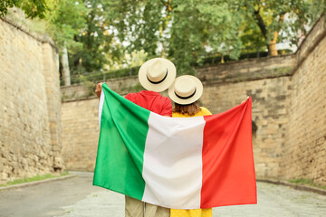 Young couple with Italian flag outdoors
