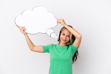 Teenager Russian girl isolated on blue background holding a thinking speech bubble