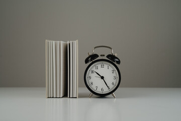 Empty book and black clock