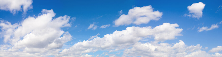 White clouds on blue sky background.
