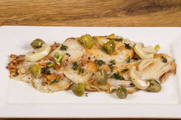 Belle Meuniere fish, fillet of fish served with olive oil sauce, mushrooms and capers
