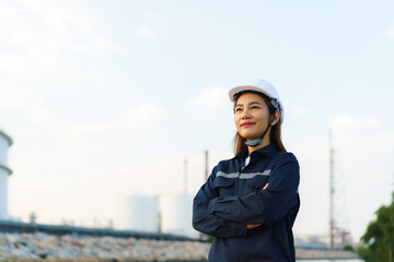 Asian woman engineer arm crossed and smile with confident looking forward to future with oil...