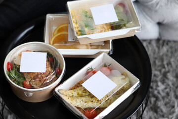 Lunch boxes with food ready for work or school, pre-cooking or diet. Baked fish, chicken with tomatoes and fruits. Healthy food delivery. Healthy restaurant food delivery, business lunch and diet plan