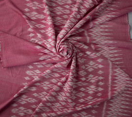 Pink color hand woven cotton fabric in Thai ancient style pattern.