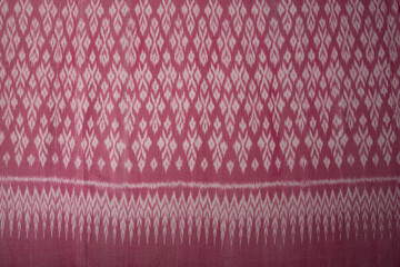 Pink color hand woven cotton fabric in Thai ancient style pattern.