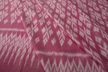 Close up of texture of pink color hand woven cotton fabric, Thai cotton detail textured textile.
