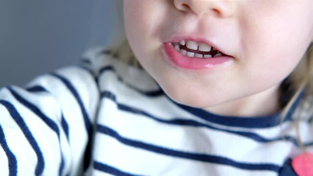 child, girl 2 years old, close-up of part of child's face, children's mouth open, concept of sensory feelings, speech disorders, correction, methods of correctional developmental exercises