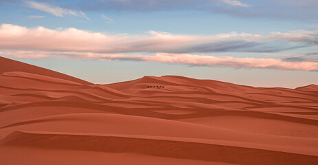 Fototapeta na wymiar Beautiful view of sand dunes in sahara desert against cloudy sky, Sand dunes with waves pattern in desert