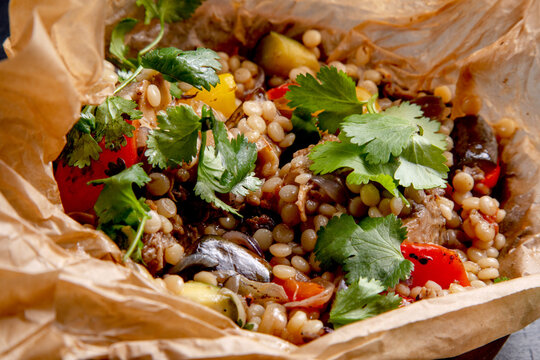 oxtails with ptim and vegetables wrapped in craft paper