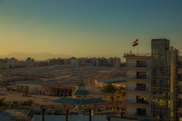 the streets of the city of Hurghada, located on the shores of the Red Sea, are illuminated by the last rays of the setting sun