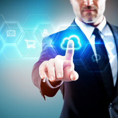 Businessman touching a blue futuristic digital screen, cloud symbol - icon