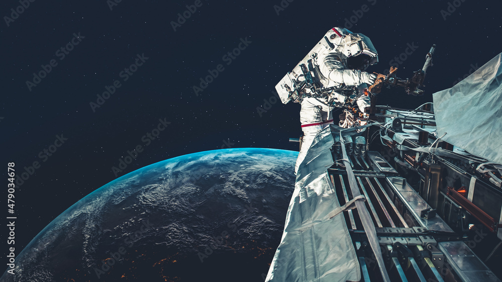 Wall mural astronaut spaceman do spacewalk while working for spaceflight mission at space station . astronaut w