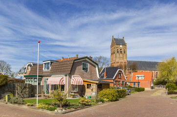 Houses and church tower in historic village Ferwert, Netherlands