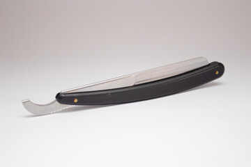 Black straight dangerous razor on a white.