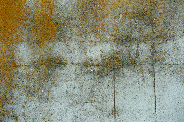 An empty concrete surface with cracks and traces of old paint. The background is a painted old wall. A place to insert text or design.