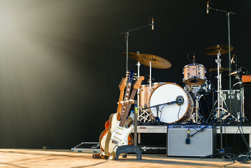 Electric guitars and drum on stage before the concert. - obrazy, fototapety, plakaty