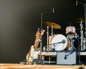 Electric guitars and drum on stage before the concert.