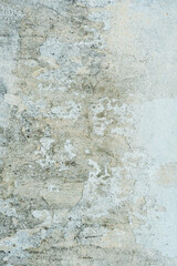 The surface of a concrete wall with old peeling paint. The texture of time-damaged paint. Multi-colored blank background for the design.