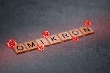 Omikron Corona Virus Variante Holzbuchstaben mit Corona Viren Spikes