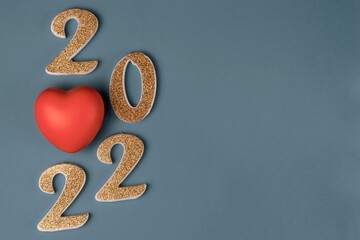 Number 2022 with a red rubber heart on a blue background. Copy space
