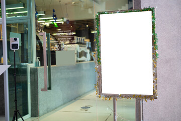 White poster mockup with black frame stand in front of blurred cafe restaurant background