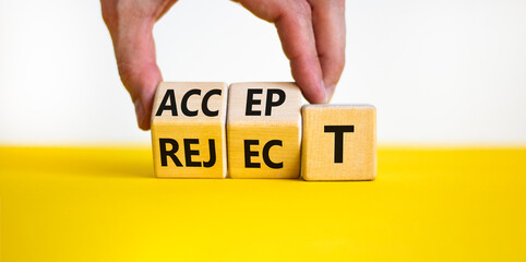 Accept or reject symbol. Businessman turns wooden cubes and changes the word reject to accept....