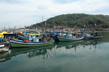 Fototapeta na wymiar Anchored fishing boats at Baithkol jetty near Karwar, India.
