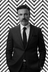 Black and white portrait of a stylish elegant senior businessman with a beard and casual business...