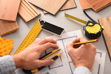 Hands in office developing interior project with wood elevated view