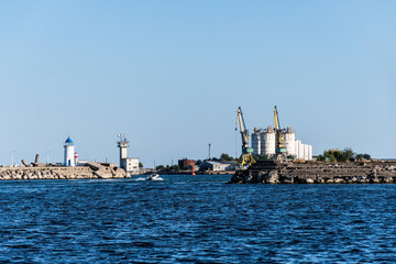  Genoves lighthouse and the industrial cranes and silos in the Mangalia harbor. Mangalia, Romania.