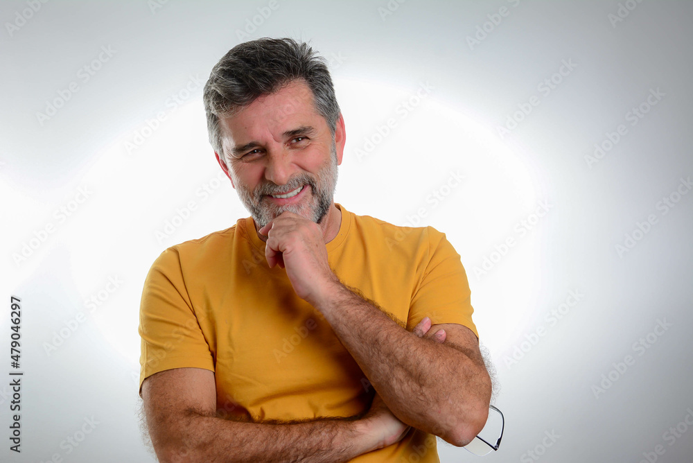 Wall mural portrait of sexy mature grey bearded man. stylish bearded senior bearded man with hand on chin looki