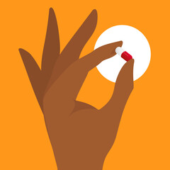 Obraz premium fingers holding up a pill